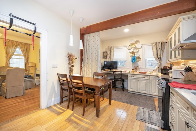 dining area featuring light wood-style floors, baseboards, beam ceiling, and recessed lighting