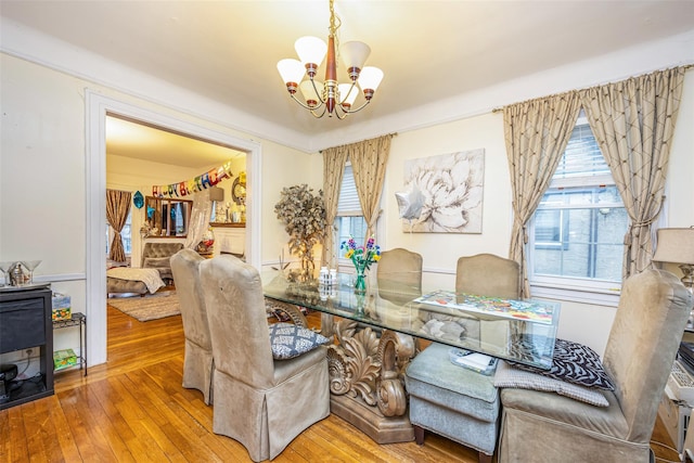 dining room with a notable chandelier and hardwood / wood-style flooring