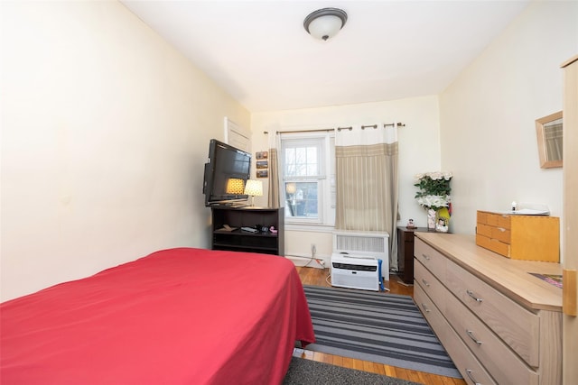 bedroom with dark wood-type flooring