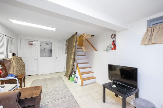 living room featuring stairway and light tile patterned flooring