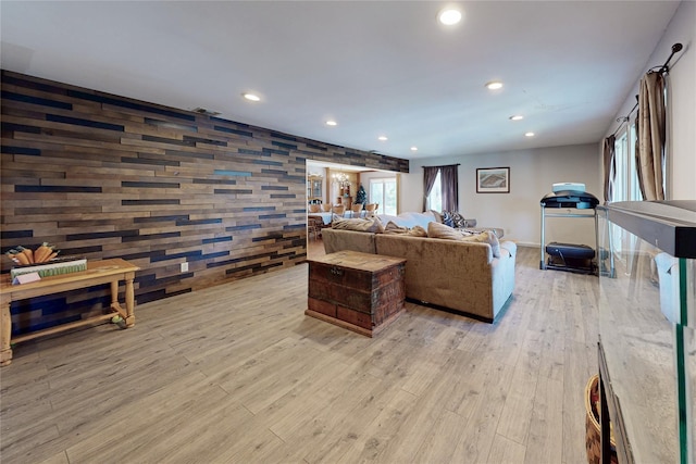 living area featuring recessed lighting, light wood-style floors, and visible vents