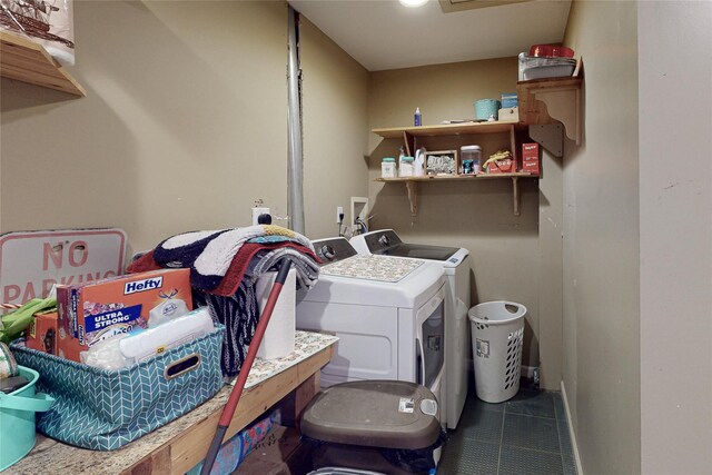 clothes washing area with washing machine and dryer, tile patterned floors, baseboards, and laundry area