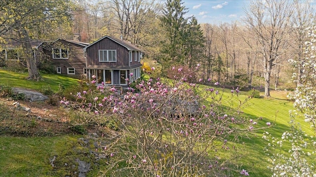view of side of home with a lawn and a chimney