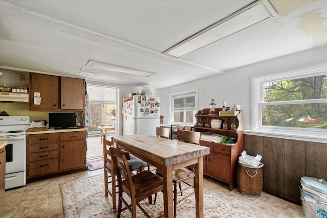 dining space featuring wood walls