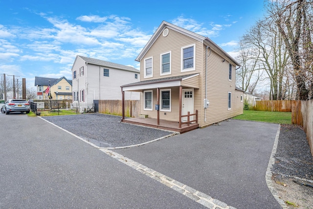 14 Fordham St, Patchogue, NY 11772 - exterior space with a residential view, fence, covered porch, and aphalt driveway