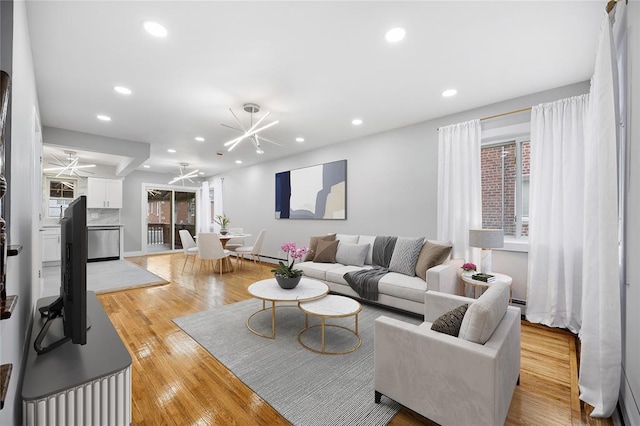 2715 Seymour Ave, Bronx, NY 10469 - living area with wood-type flooring, a notable chandelier, and recessed lighting