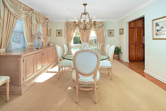 dining room with an inviting chandelier, crown molding, light wood-type flooring, and baseboards