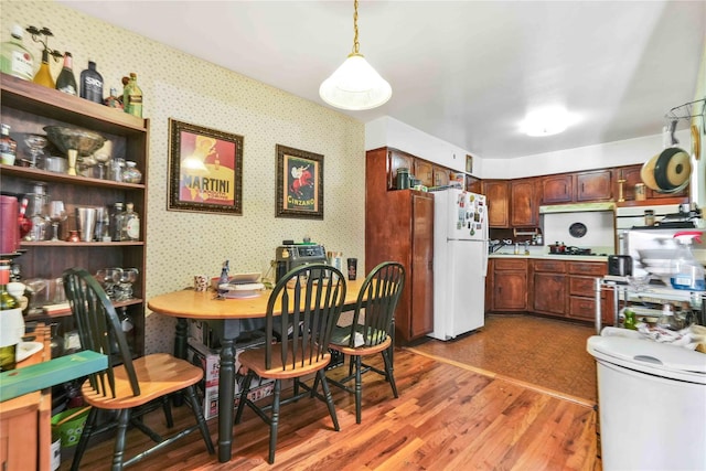 3145 37th St, Astoria, NY 11103 - dining area with light wood-type flooring and wallpapered walls