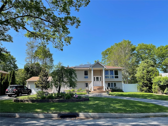 69 Fulton Blvd, Commack, NY 11725 - bi-level home with a front yard and a garage
