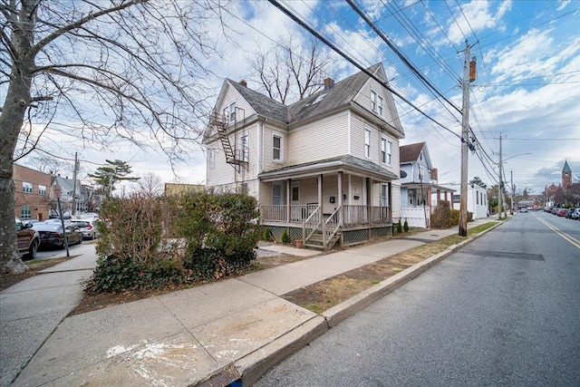 61 Haseco Ave, Port Chester, NY 10573 - view of front of house featuring a residential view, covered porch, and a chimney