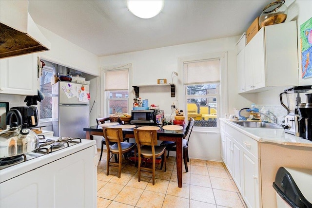61 Haseco Ave, Port Chester, NY 10573 - kitchen with white appliances, light countertops, healthy amount of natural light, and custom range hood
