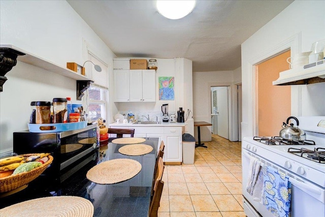 61 Haseco Ave, Port Chester, NY 10573 - kitchen featuring white gas stove, white cabinetry, open shelves, ventilation hood, and light countertops