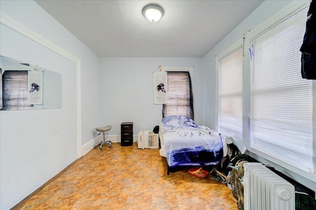 61 Haseco Ave, Port Chester, NY 10573 - bedroom featuring radiator heating unit and multiple windows