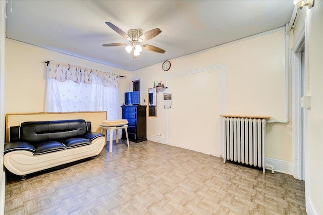 61 Haseco Ave, Port Chester, NY 10573 - living area with radiator heating unit and a ceiling fan