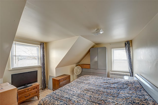 bedroom with vaulted ceiling and radiator heating unit
