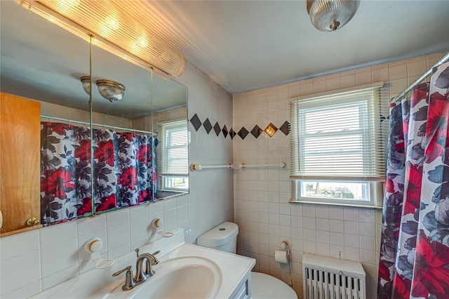 bathroom featuring radiator heating unit, decorative backsplash, vanity, tile walls, and toilet