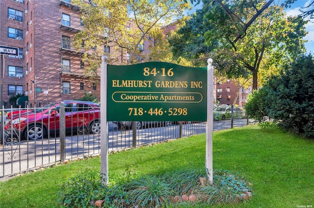 community sign with a yard and fence
