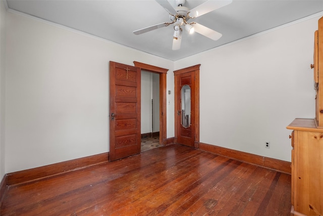 empty room with crown molding, baseboards, ceiling fan, and hardwood / wood-style flooring