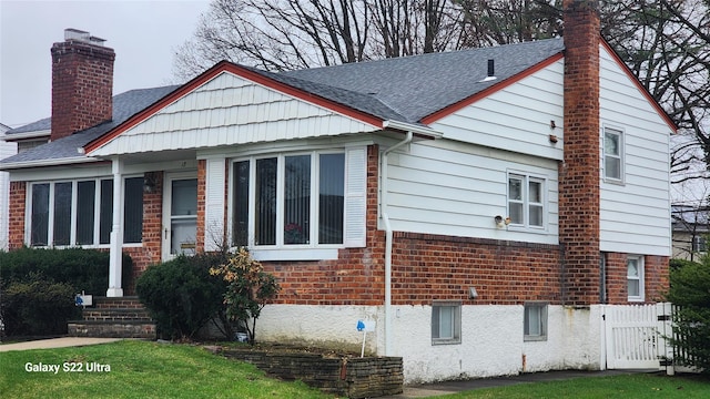 18 Hilary Ln, Westbury, NY 11590 - view of side of home with brick siding, a chimney, and a shingled roof