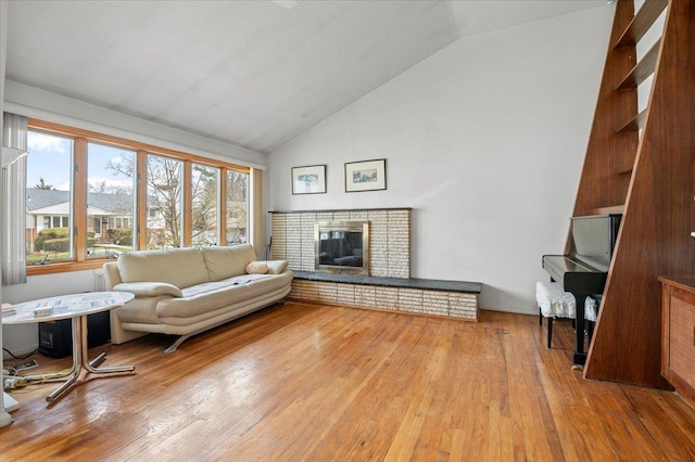18 Hilary Ln, Westbury, NY 11590 - living area with high vaulted ceiling, wood finished floors, and a fireplace