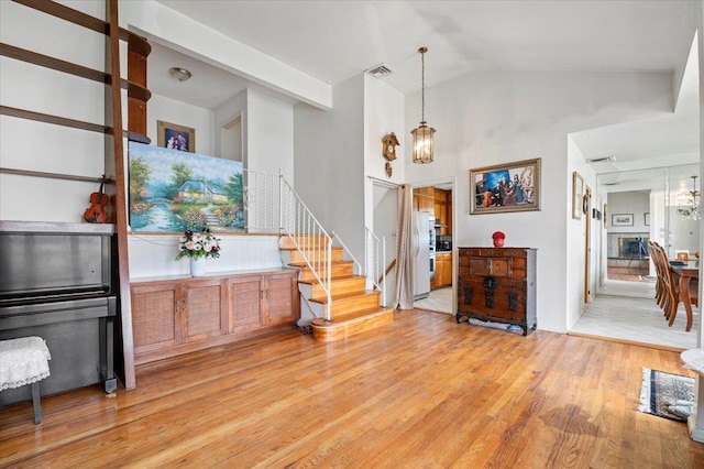 18 Hilary Ln, Westbury, NY 11590 - interior space with visible vents, vaulted ceiling, light wood-style floors, and stairs