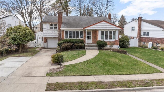 18 Hilary Ln, Westbury, NY 11590 - tri-level home featuring a chimney, a front yard, and fence