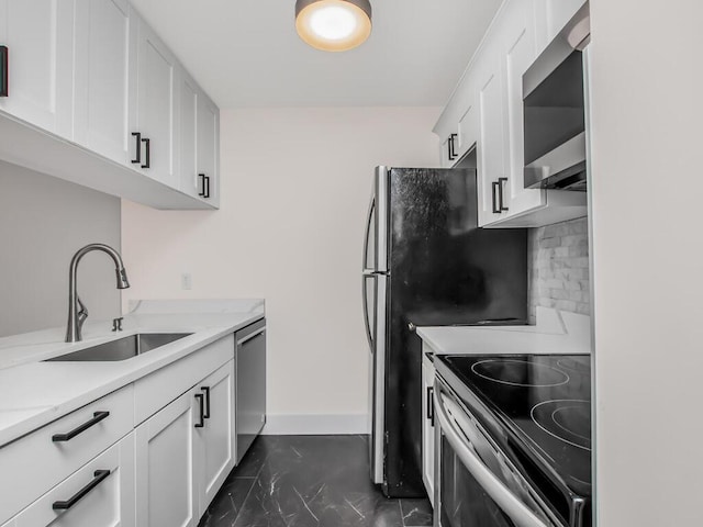 25 Rockledge Ave Unit 117, White Plains, NY 10601 - kitchen featuring a sink, tasteful backsplash, appliances with stainless steel finishes, and white cabinets