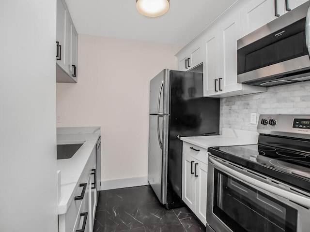 25 Rockledge Ave Unit 117, White Plains, NY 10601 - kitchen featuring baseboards, light countertops, white cabinets, decorative backsplash, and appliances with stainless steel finishes