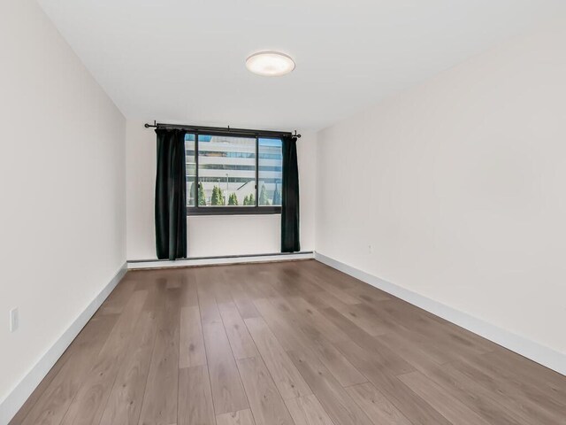 25 Rockledge Ave Unit 117, White Plains, NY 10601 - spare room with baseboards and wood finished floors