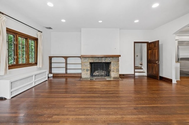 51 Valley Rd, Larchmont, NY 10538 - unfurnished living room featuring a fireplace, wood finished floors, recessed lighting, arched walkways, and stairway