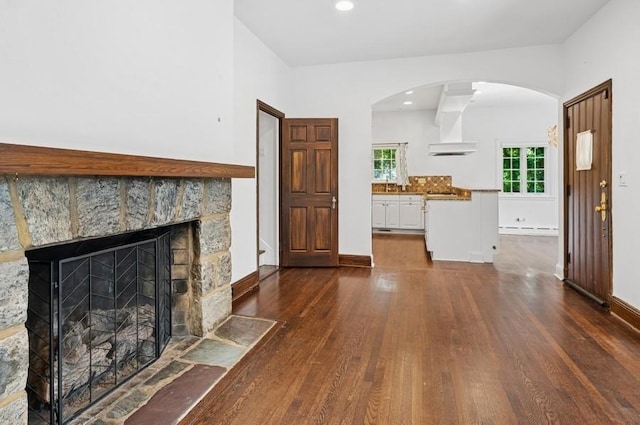 51 Valley Rd, Larchmont, NY 10538 - living area featuring dark wood finished floors, arched walkways, a fireplace, and recessed lighting