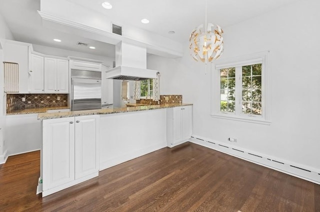 51 Valley Rd, Larchmont, NY 10538 - kitchen featuring built in refrigerator, custom range hood, baseboard heating, light stone countertops, and backsplash