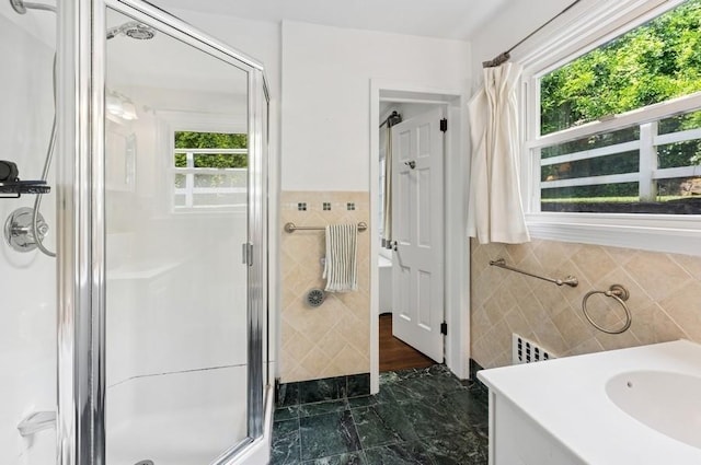 51 Valley Rd, Larchmont, NY 10538 - bathroom with tile walls, a stall shower, and vanity