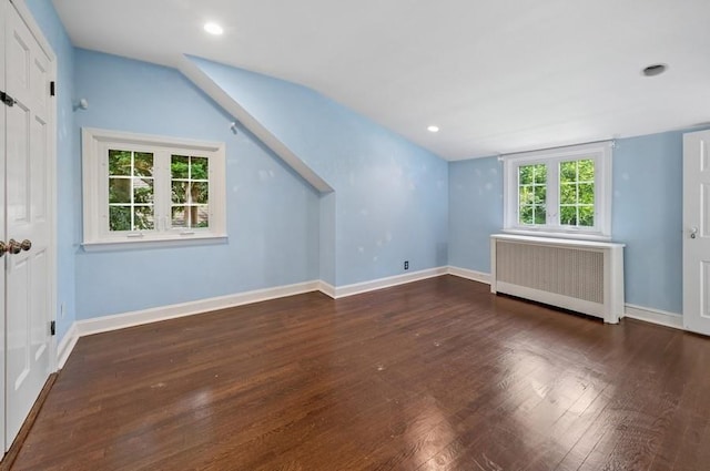 51 Valley Rd, Larchmont, NY 10538 - unfurnished living room featuring radiator heating unit, wood finished floors, vaulted ceiling, and recessed lighting