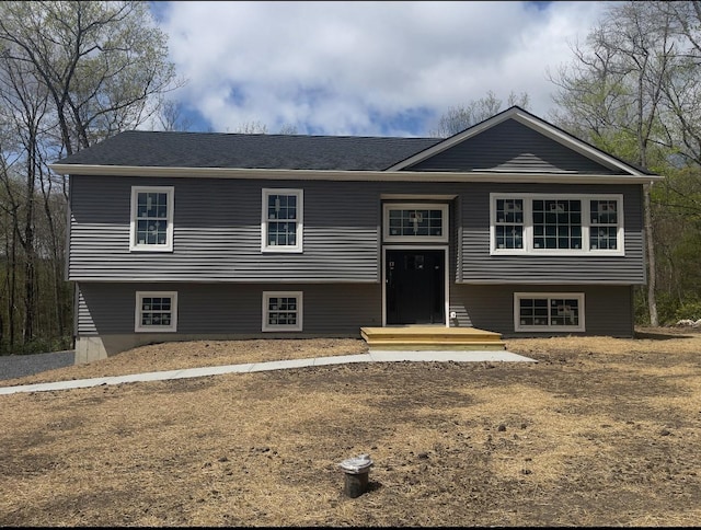 raised ranch with roof with shingles