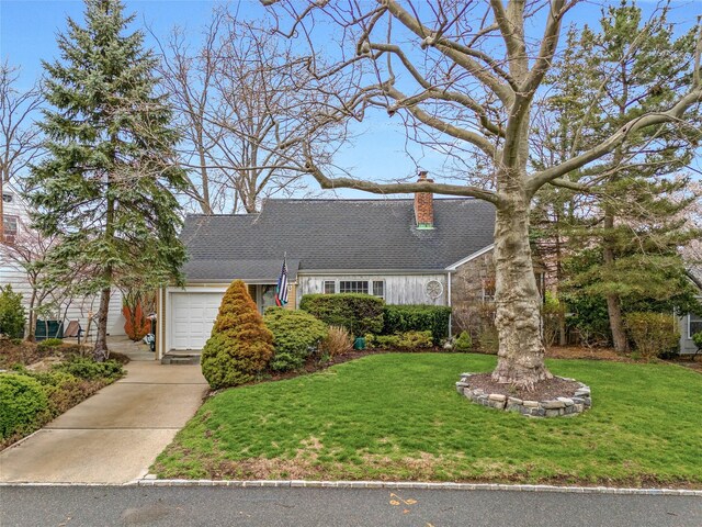 52-06 Bowne St, Flushing, NY 11355 - view of front facade featuring a front yard, driveway, a chimney, and an attached garage