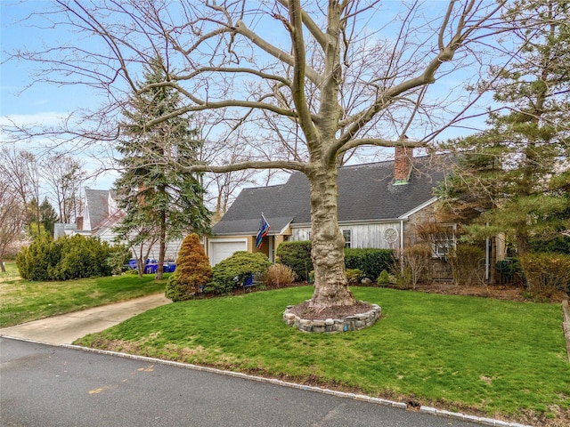 52-06 Bowne St, Flushing, NY 11355 - cape cod house featuring a front yard, driveway, and a chimney