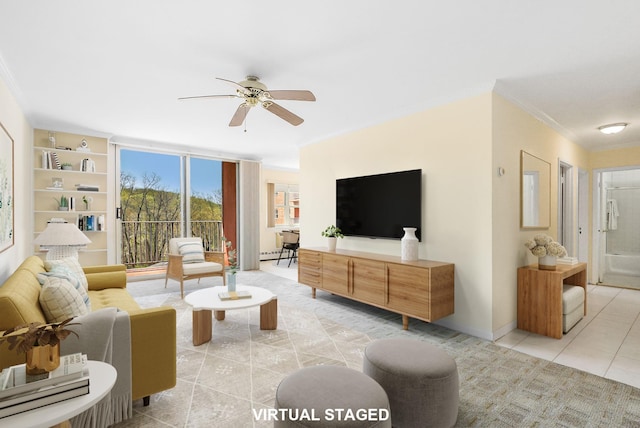 living area featuring a baseboard radiator, baseboards, light tile patterned flooring, ornamental molding, and a ceiling fan