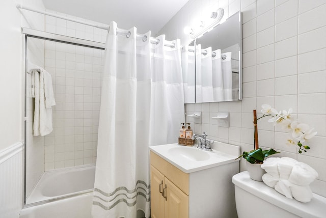 full bath featuring tile walls, vanity, decorative backsplash, shower / tub combo, and toilet