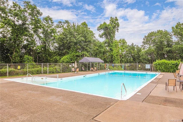 community pool featuring a patio and fence