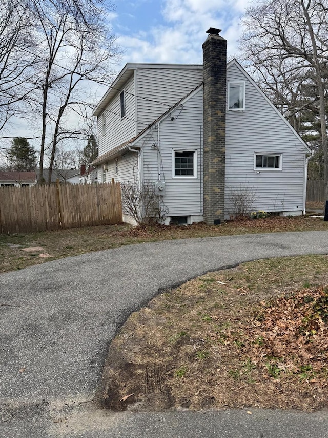 250 Wheeler Rd, Hauppauge, NY 11788 - view of side of property with a chimney and fence