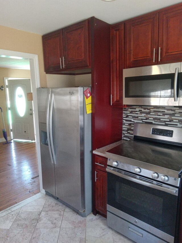 250 Wheeler Rd, Hauppauge, NY 11788 - kitchen featuring decorative backsplash, reddish brown cabinets, and stainless steel appliances