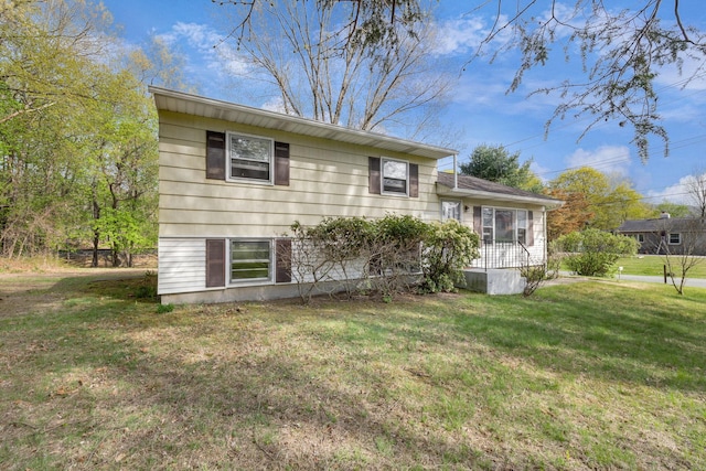 back of house with a lawn