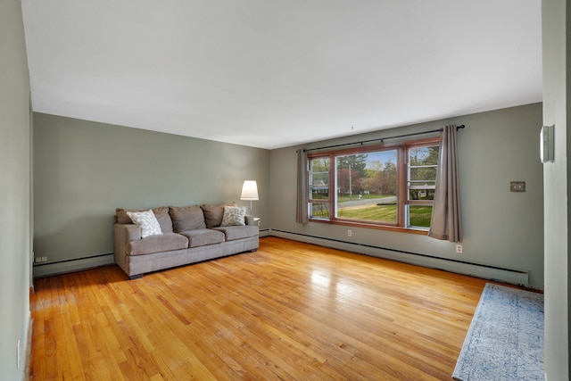 living room featuring baseboard heating, a baseboard heating unit, and light wood finished floors