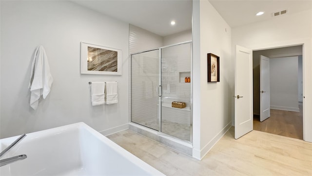 8 Marker Rdg Unit 4, Irvington, NY 10533 - bathroom featuring a freestanding tub, a stall shower, wood finished floors, and recessed lighting