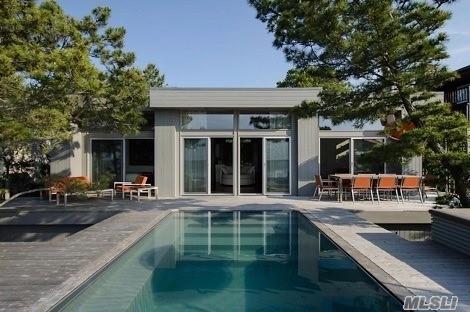 248 Bay Walk, Fire Island Pines, NY 11782 - rear view of house featuring outdoor dining space and an outdoor pool