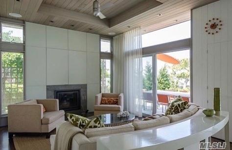 248 Bay Walk, Fire Island Pines, NY 11782 - living room with wooden ceiling, a tile fireplace, and a high ceiling