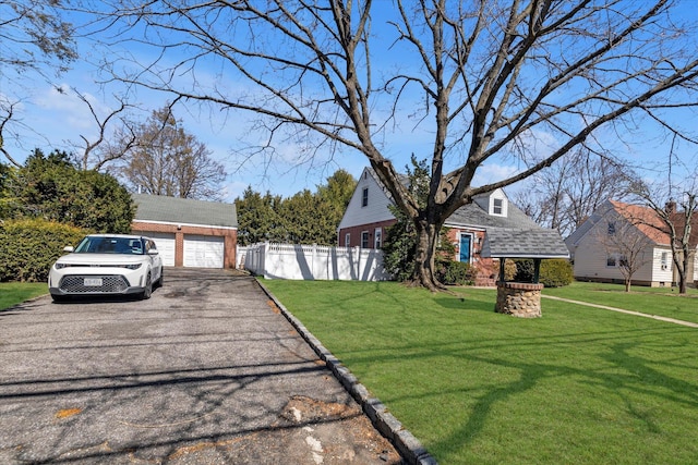 exterior space featuring fence, an outdoor structure, and a garage