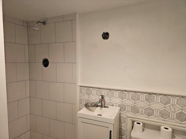23 Beverly Rd, Glen Cove, NY 11542 - bathroom with tiled shower, wainscoting, tile walls, and vanity