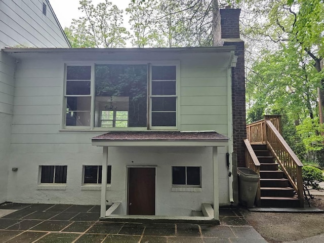 23 Beverly Rd, Glen Cove, NY 11542 - back of house featuring a chimney, stairs, and a patio area